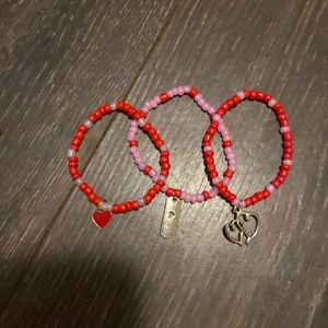 Valentine’s Day themed bracelets: two hearts and a love tagged one.